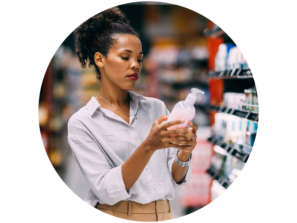 Shopper reading the label on a personal care item in a store