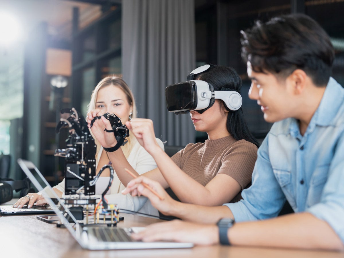 College students collaborate with research team to do experiment with educational robots. Wearing virtual reality goggle help learner to engage real, interacting situations with immersive experience.