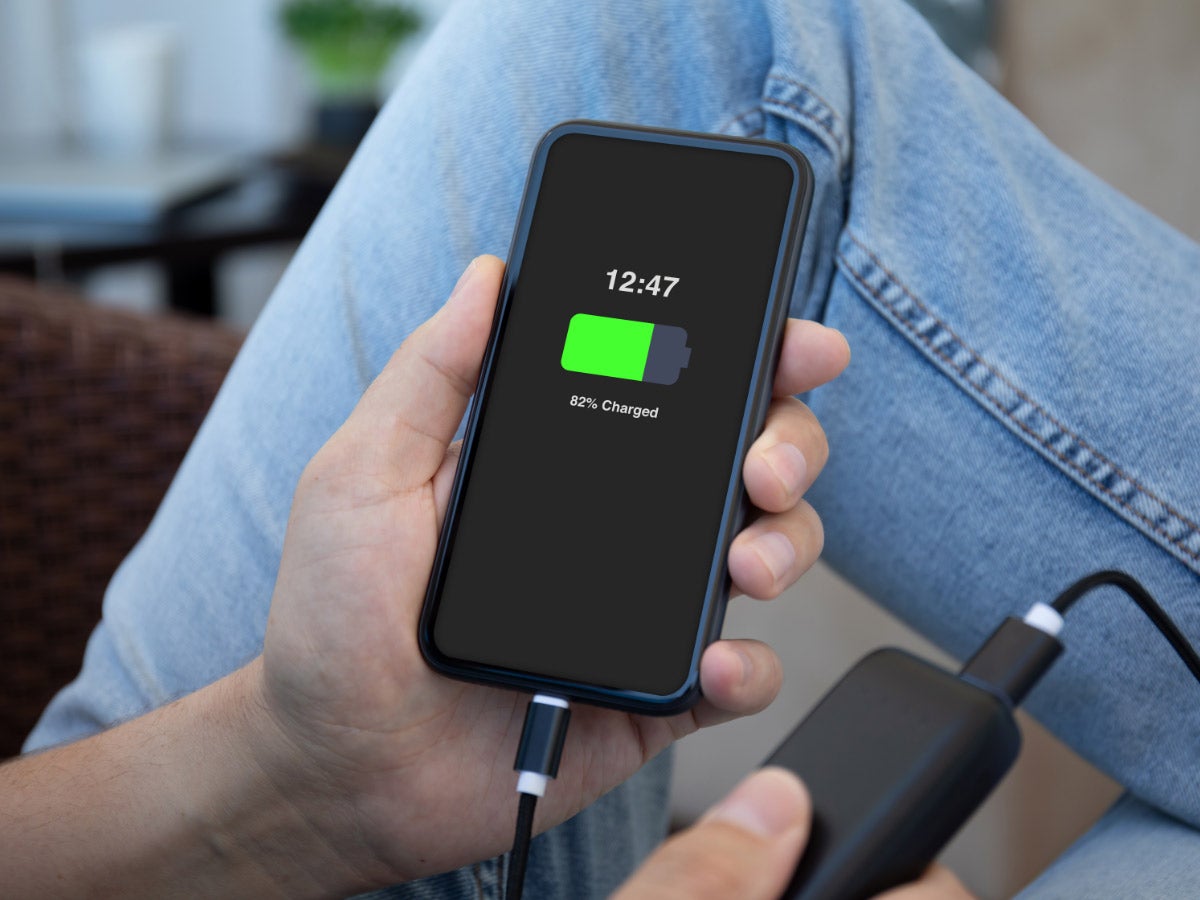 Person charging their cell phone with a power bank